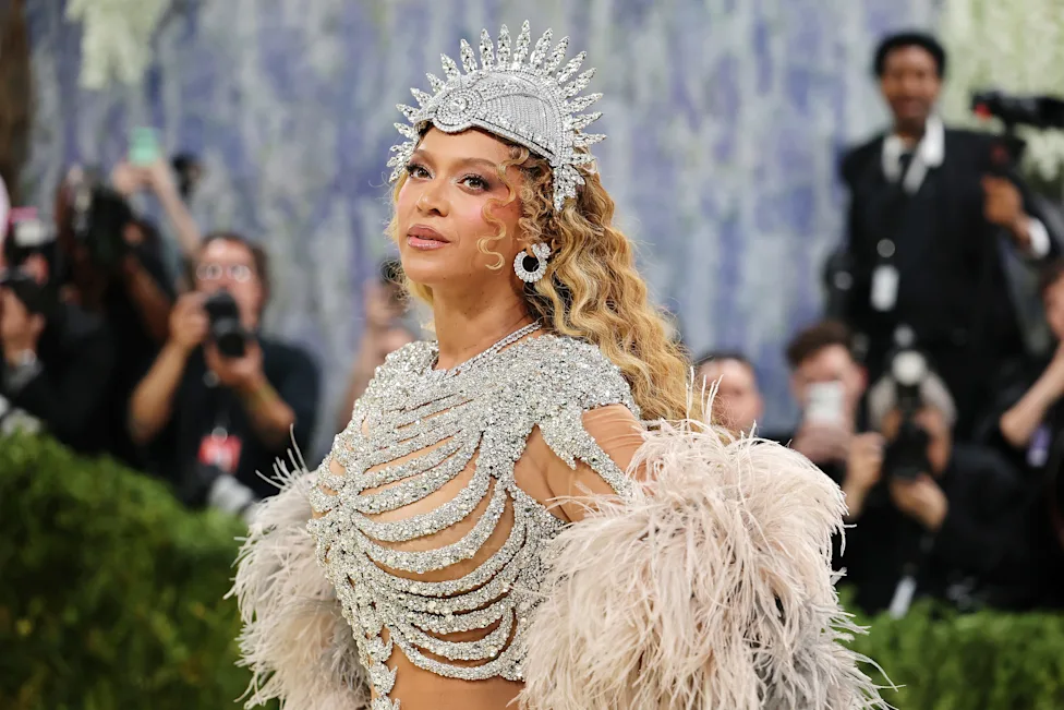 Beyoncé in a silver crystalline outfit and crown at a formal event