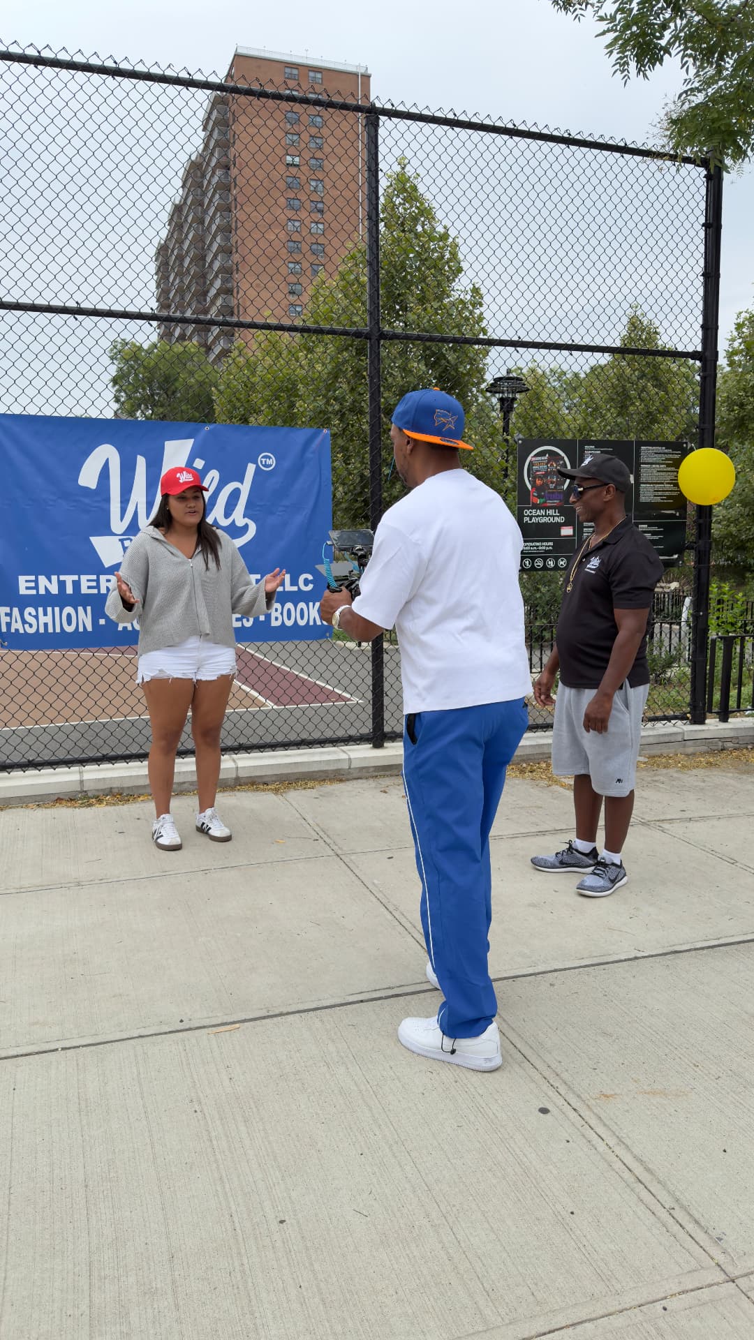On-camera interview in front of the Wild Bunch Entertainment banner at Ocean Hill Playground