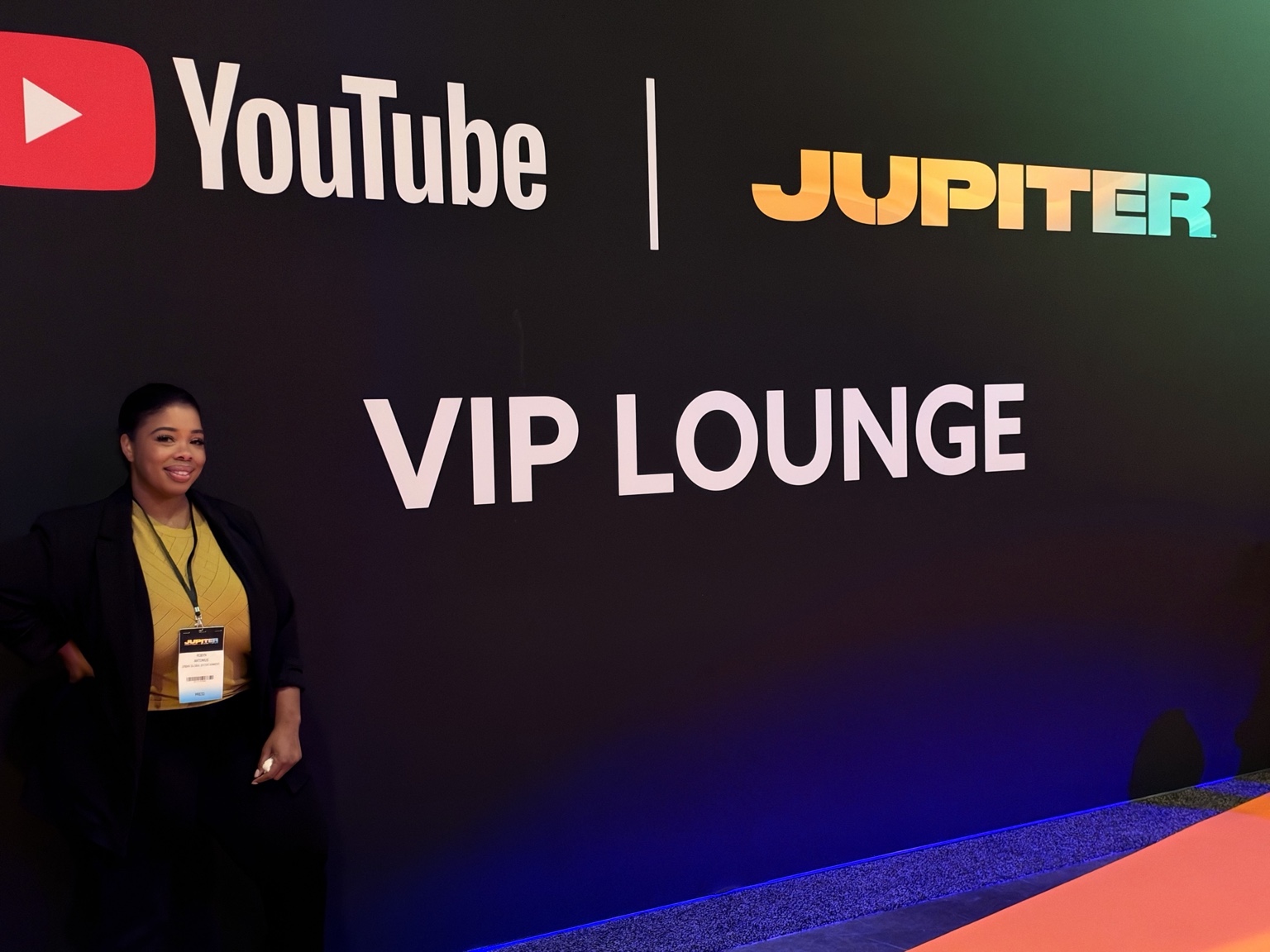 Robyn Antonius beside YouTube VIP Lounge signage