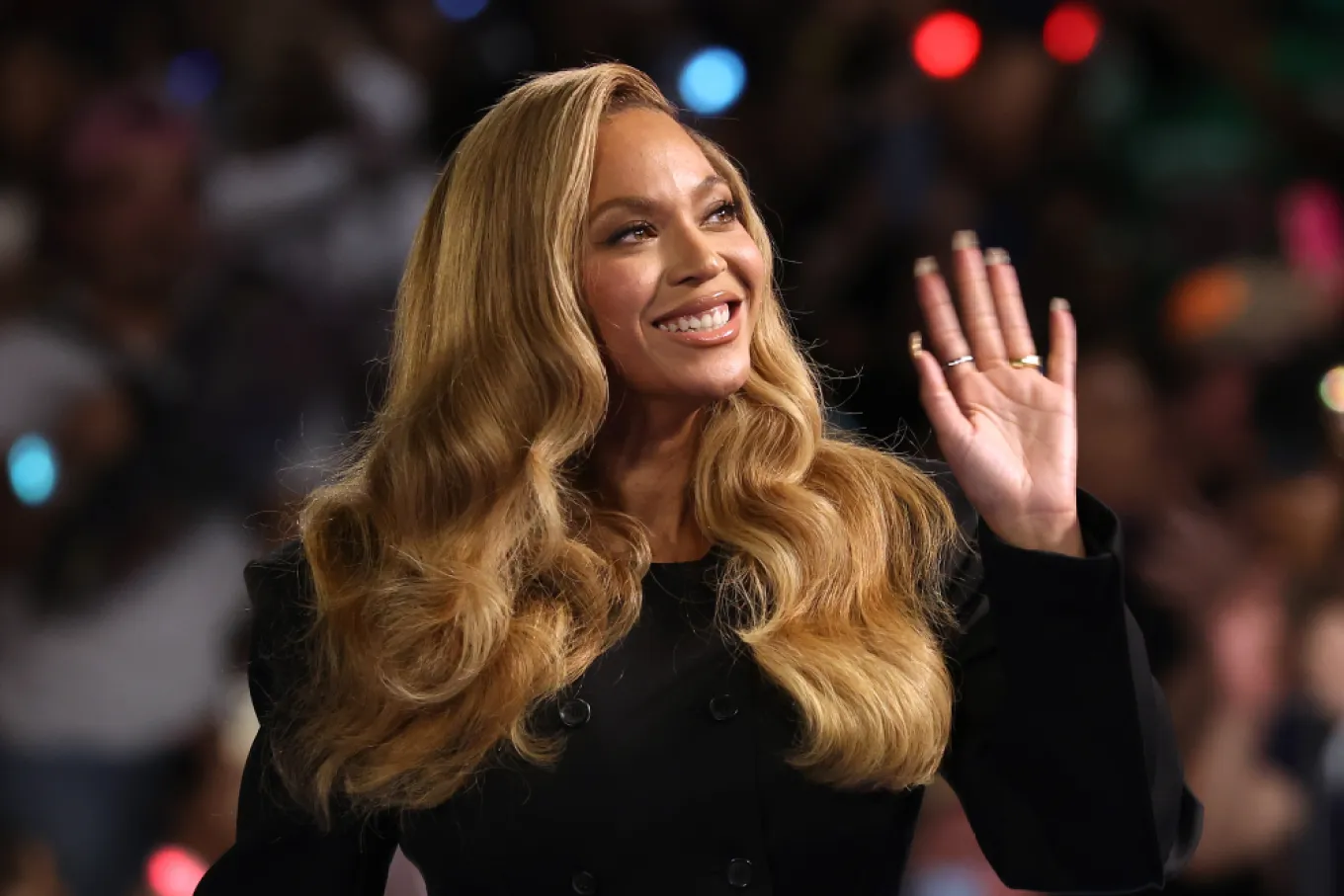 Beyoncé smiling and waving at a formal event